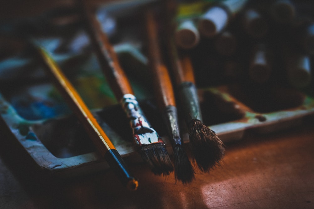 selective focus photography of paint brushes