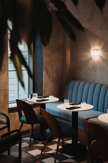 Cozy corner of Sendo Café with soft blue and white tones, sunlight filtering through a window.