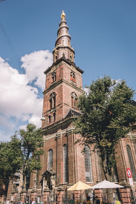 brown concrete building under blue sky during daytime in Church of Our Saviour Denmark