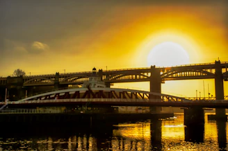 A hopeful sunrise over a bridge symbolizing connection and new beginnings.