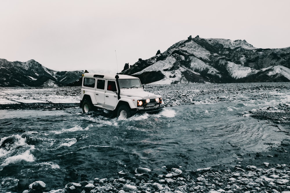 white suv on rocky road