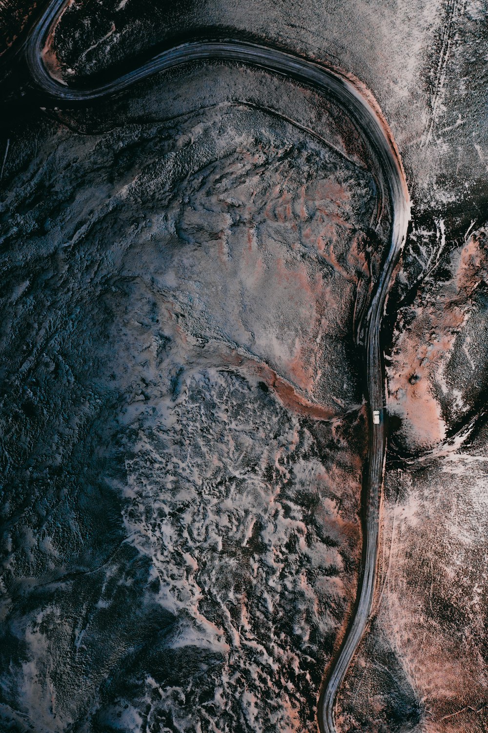 aerial view of road in the middle of snow covered ground