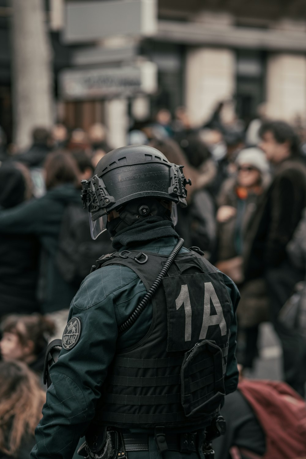 Mann in schwarz-grauer Tarnuniform mit schwarzem Helm