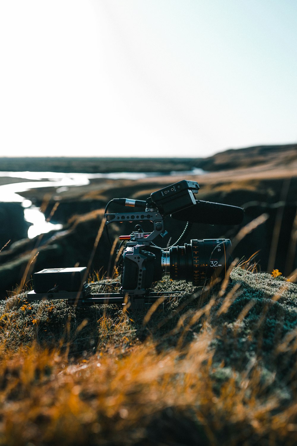 black dslr camera on brown grass during daytime