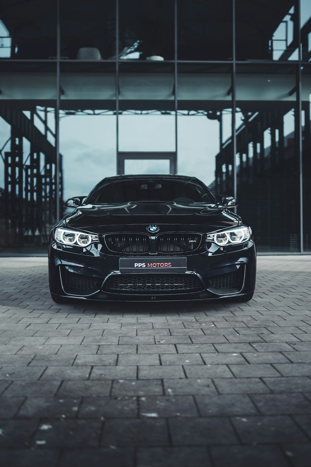 black bmw m 3 parked on gray concrete pavement