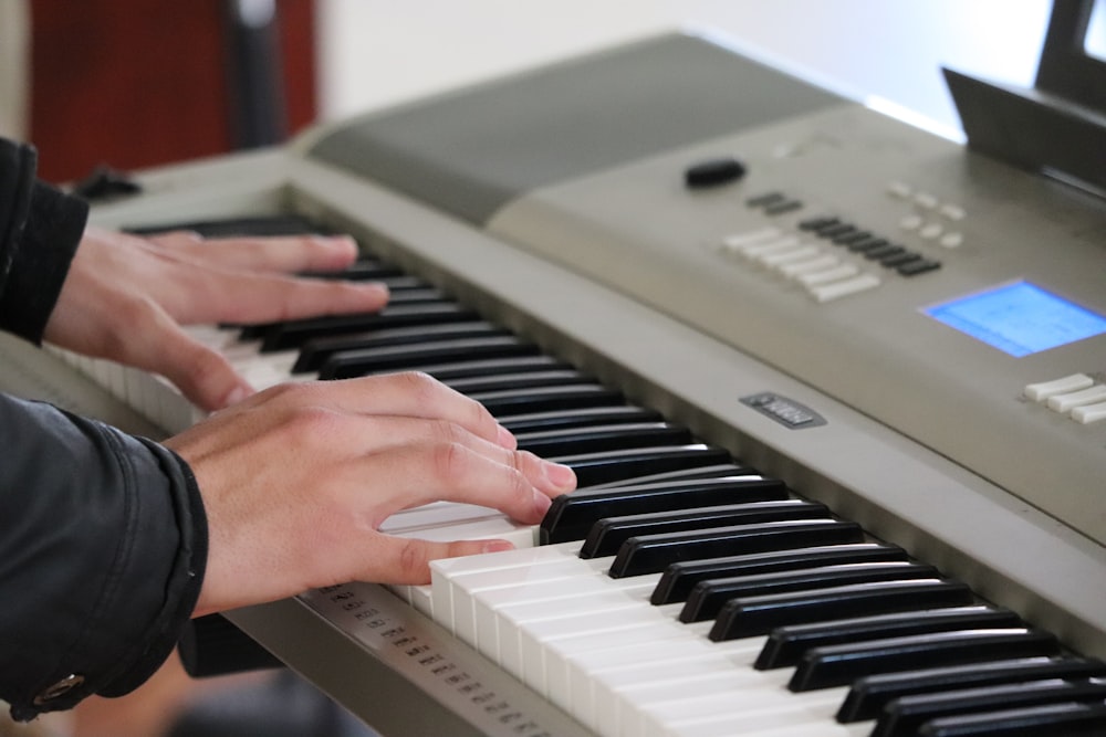 person playing piano inside room