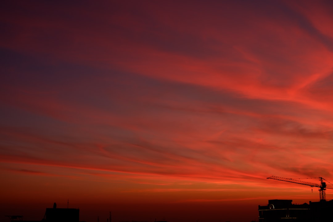 silhouette of building under blue sky