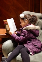 A young girl reading a classic fable aloud with animated expressions.