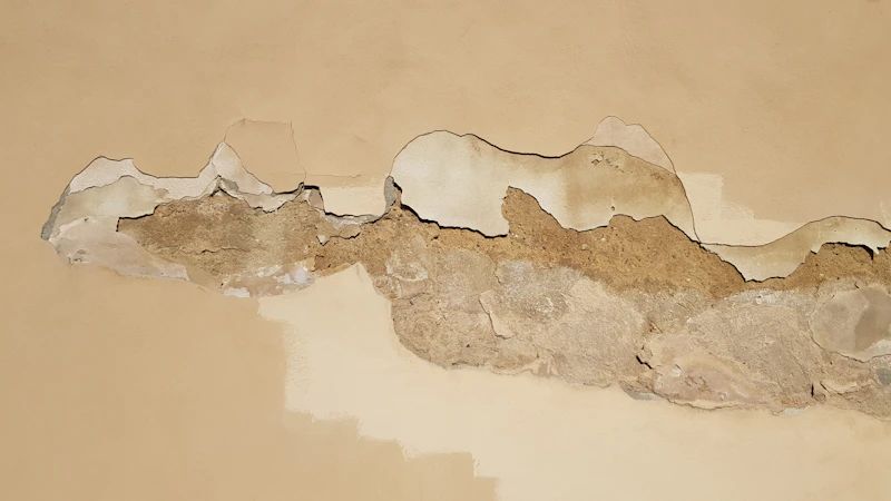 Interior wall plaster cracked and damaged from water intrusion