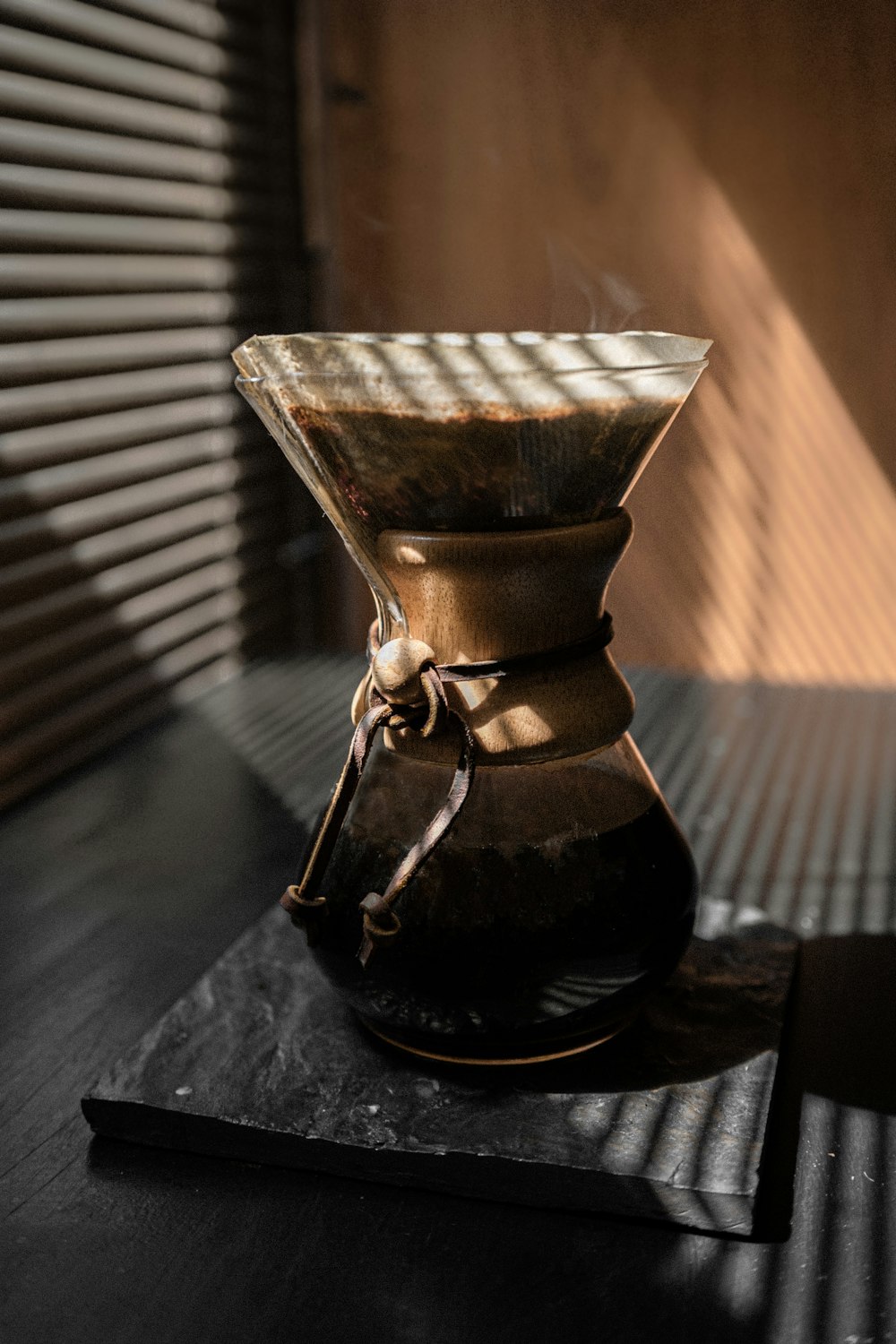 brown glass vase on brown wooden table