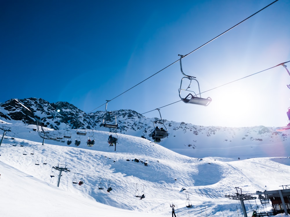 cable cars over snow covered mountain during daytime