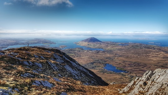brown and black mountains under blue sky during daytime in Connemara National Park Ireland