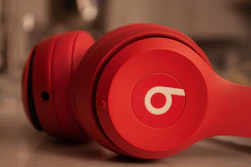 a pair of red headphones sitting on top of a counter