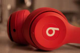 a pair of red headphones sitting on top of a counter