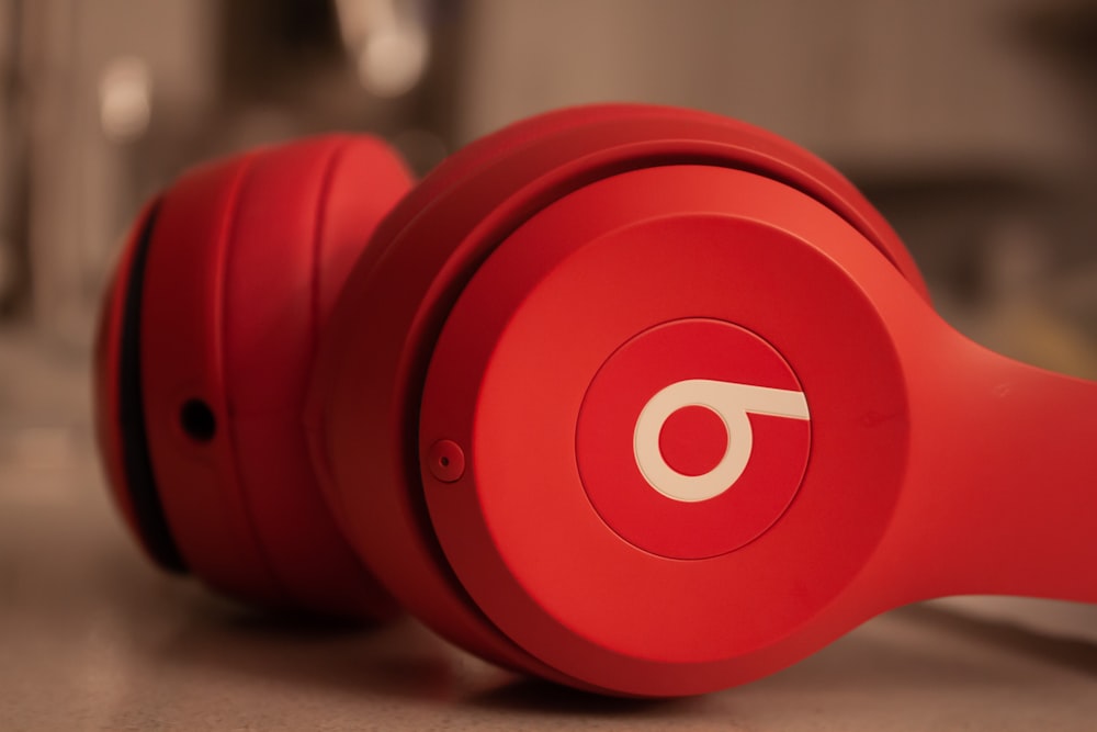 a pair of red headphones sitting on top of a counter