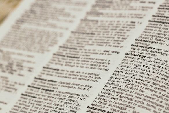 A close-up view of a dictionary page focusing on words related to 'technology.' The text is clear, with bold headings for each term and line-by-line definitions.