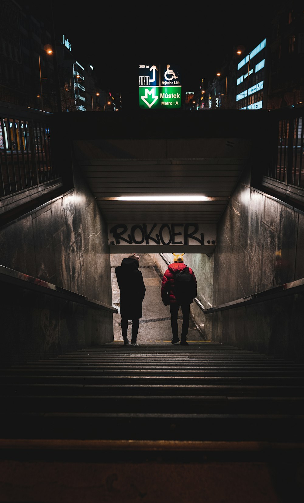 person in red shirt walking on tunnel