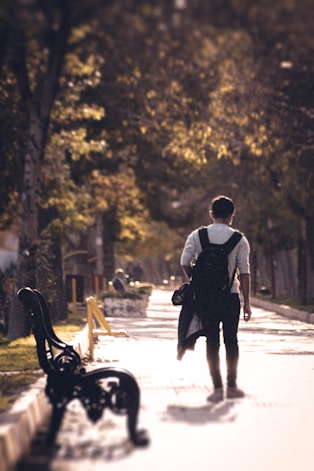 man and woman walking on road during daytime
