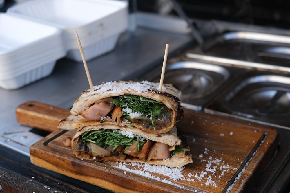 burger with lettuce and tomato on brown wooden tray