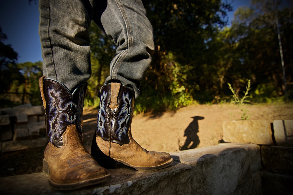 person wearing brown leather cowboy boots