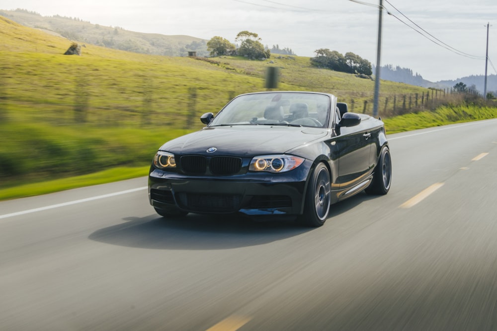 black bmw convertible on road during daytime