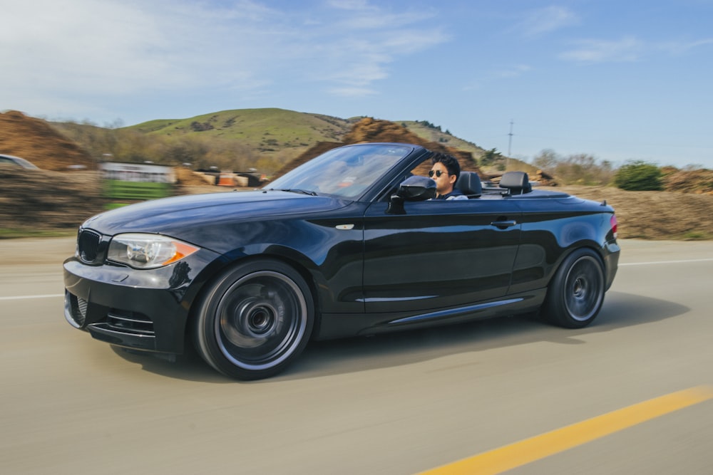 blue convertible coupe on road during daytime