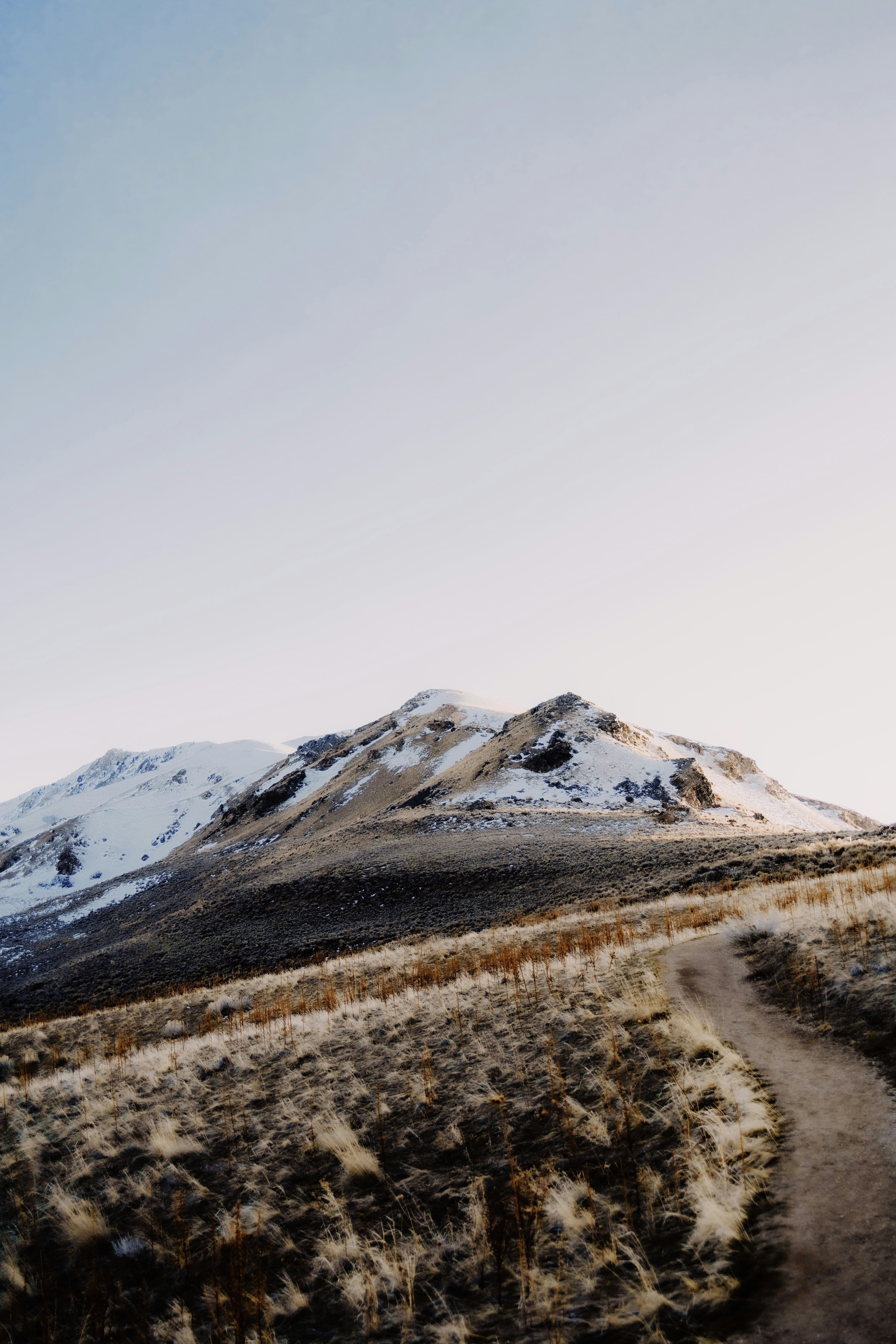 snow covered mountain under white sky during daytime