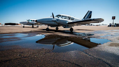 white and blue airplane on brown sand during daytime
