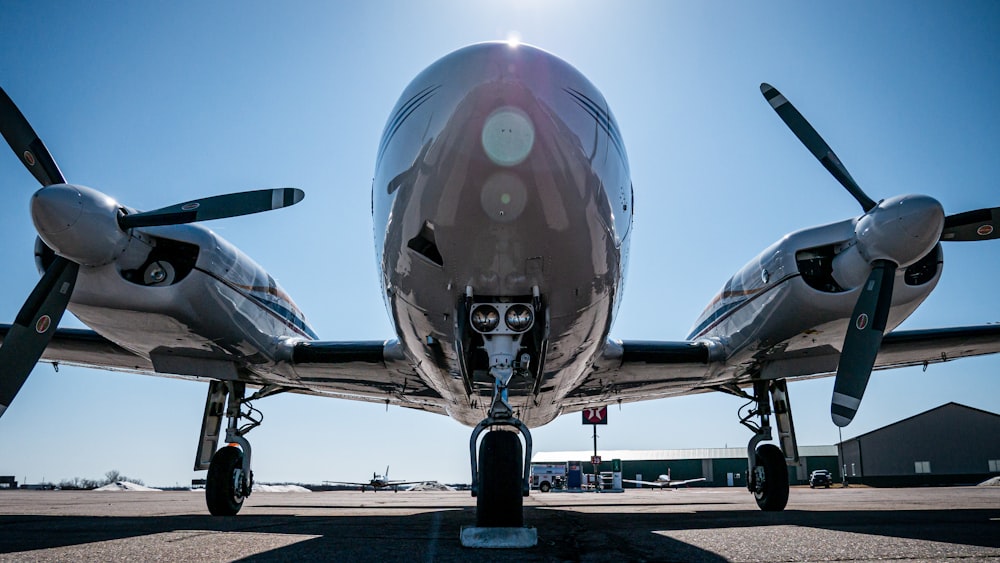 gray and white airplane on airport during daytime