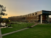 brown building with green grass field