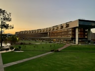 brown building with green grass field