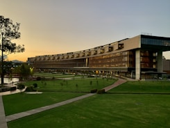 brown building with green grass field