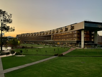 brown building with green grass field