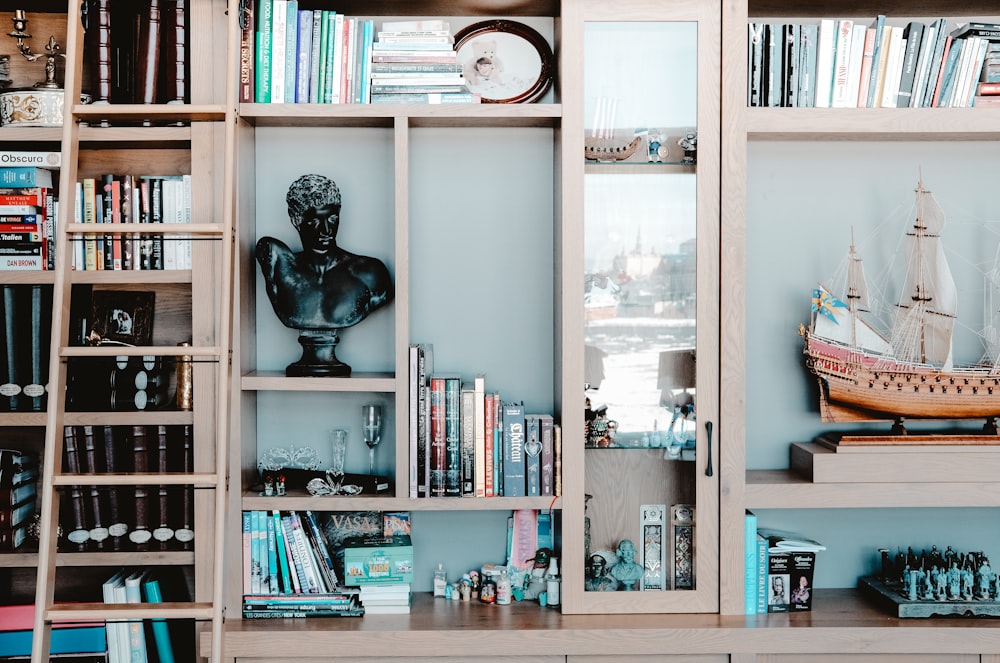 white wooden shelf with books and figurines