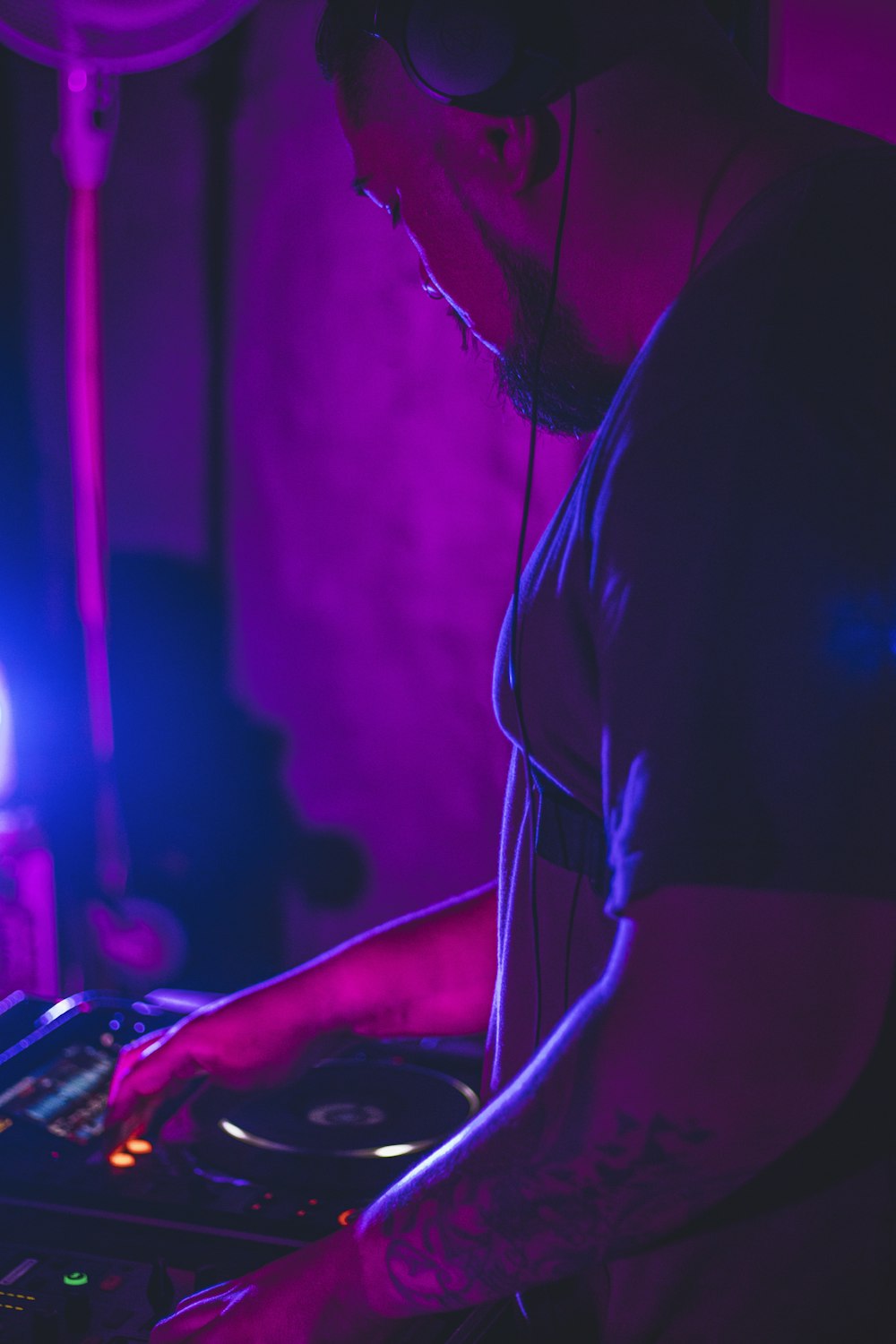 man in black t-shirt playing dj mixer