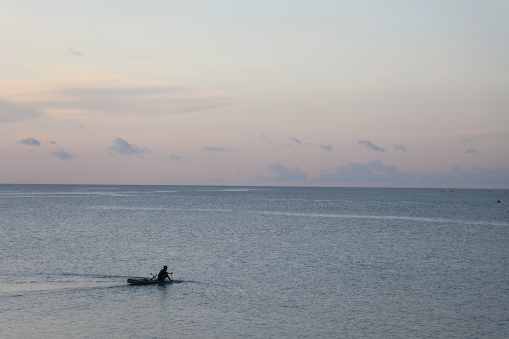 person riding on boat on sea during daytime