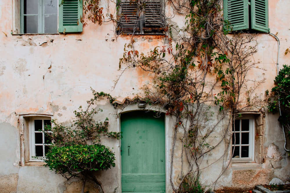 green wooden window on beige concrete building