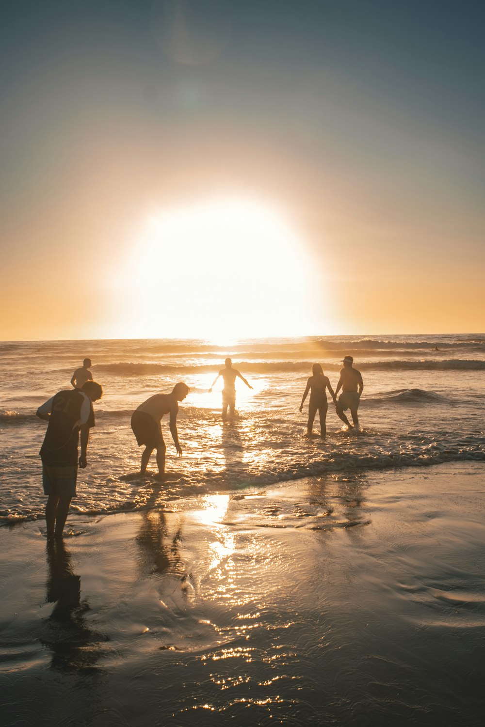 silhouette of people on beach during sunset