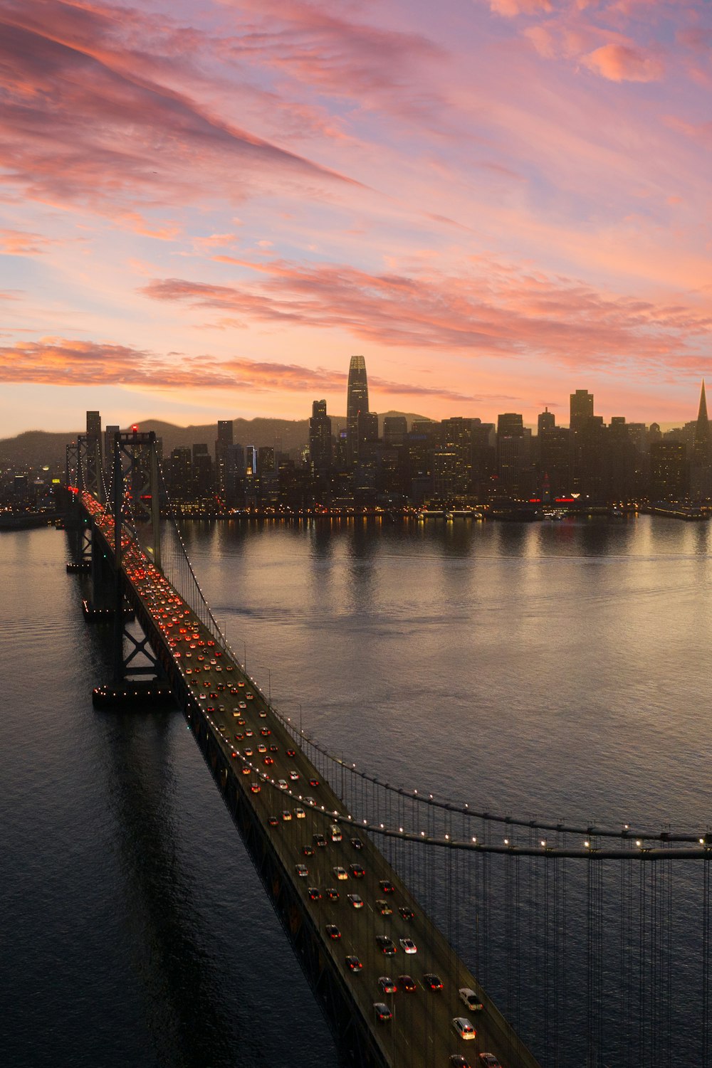 bridge over water near city buildings during daytime