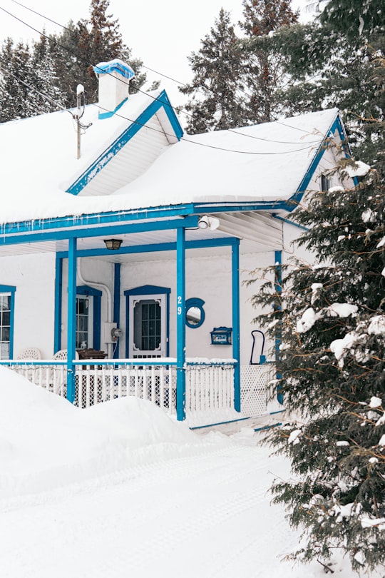 blue and white wooden house covered with snow in Sainte-Agathe-des-Monts Canada