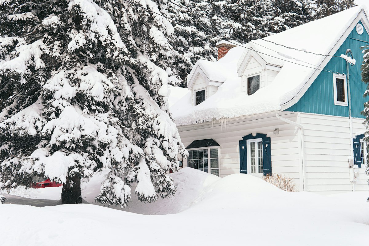 House and driveway covered with snow in winter