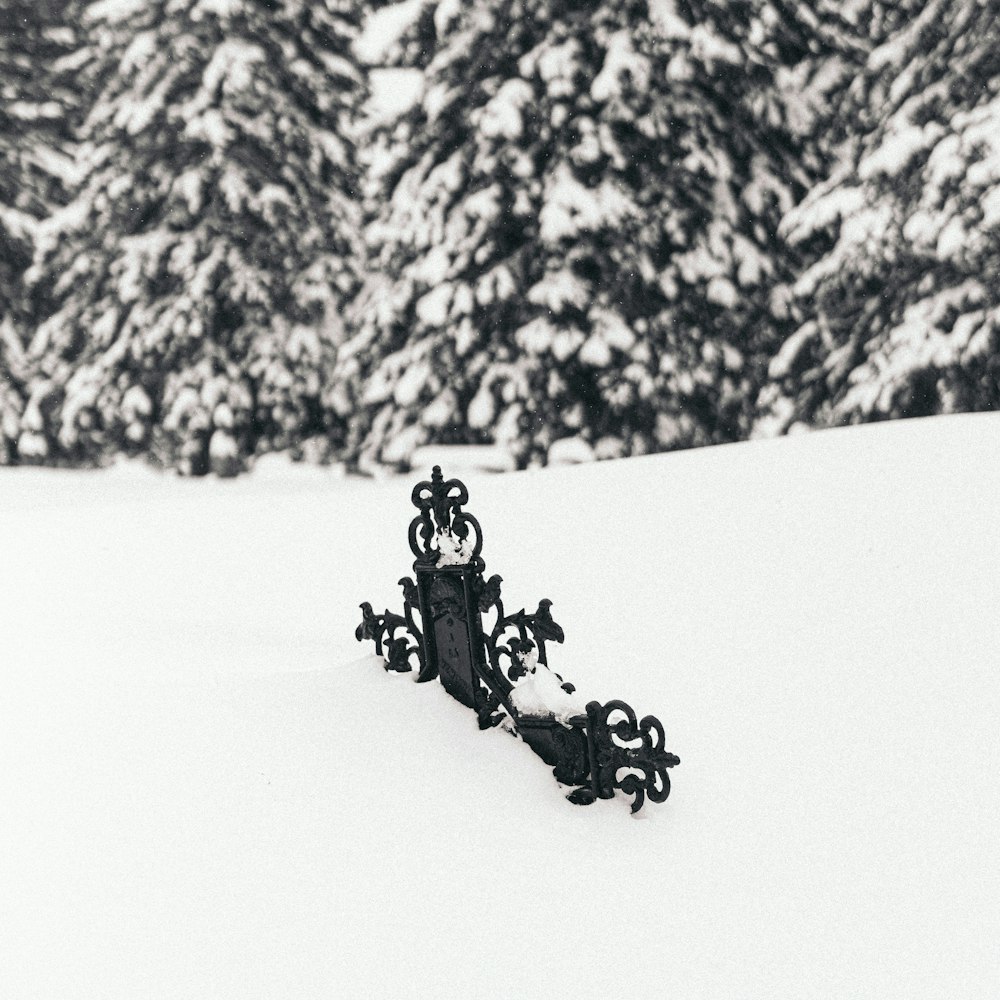2 people riding on black horse on snow covered ground during daytime