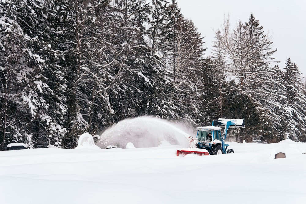 man riding on red and black snow mobile during daytime