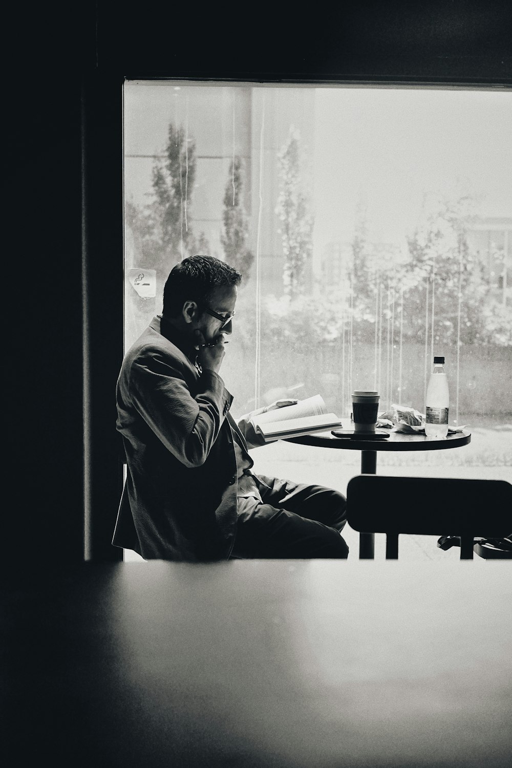 man in black jacket sitting by the table