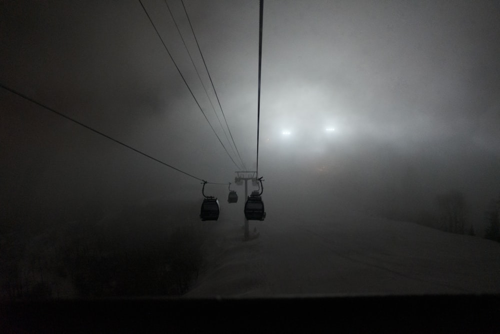 black cable cars on gray sky