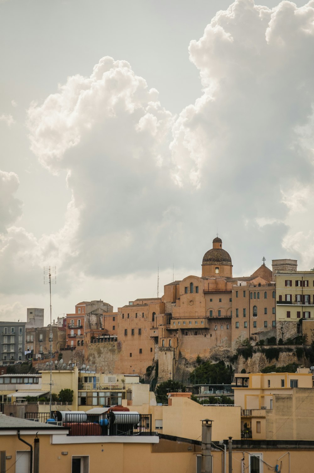 brown concrete building under white clouds during daytime