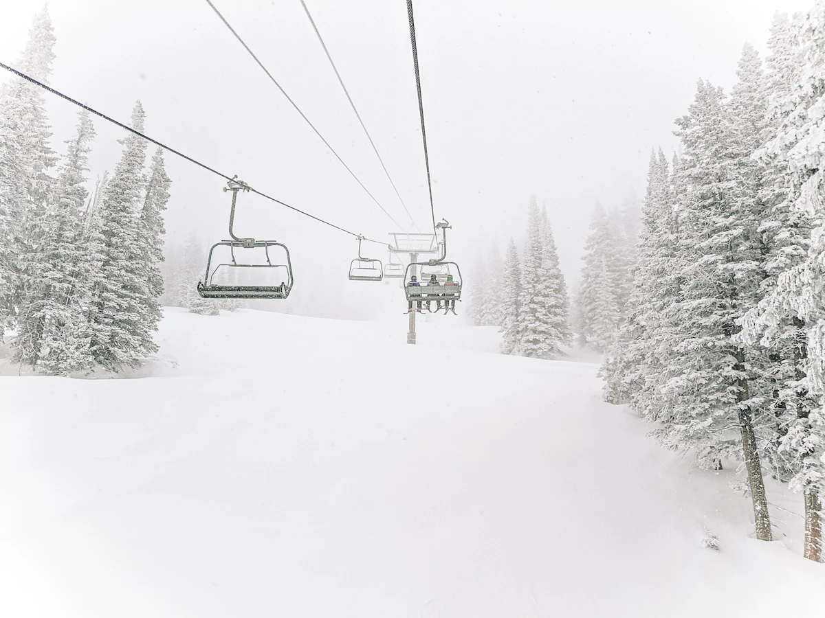 Chairlift running through a snowy forest at a Colorado ski area