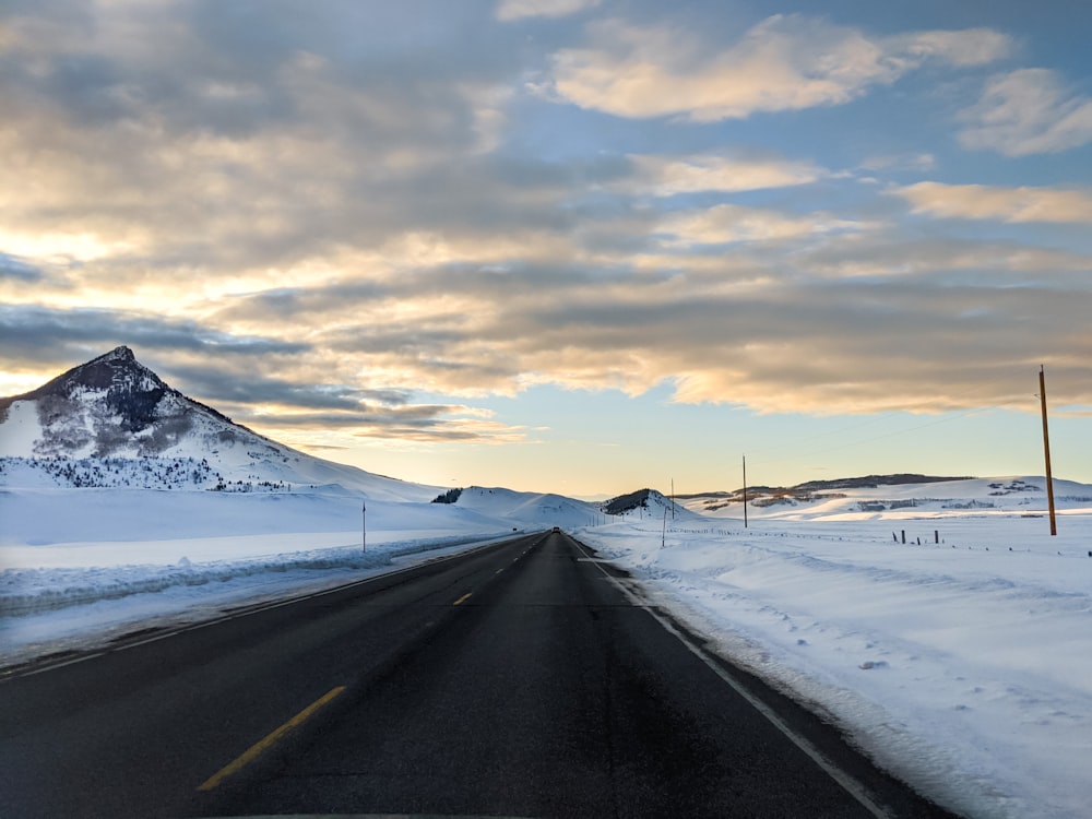 snow covered road during daytime