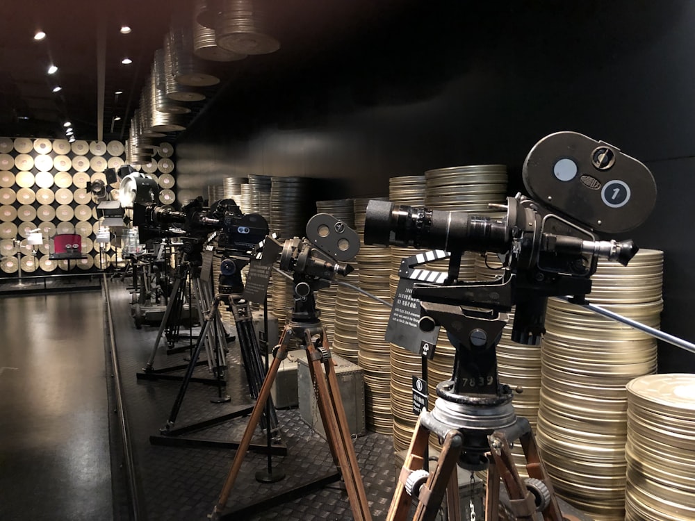 black and silver camera on brown wooden stand