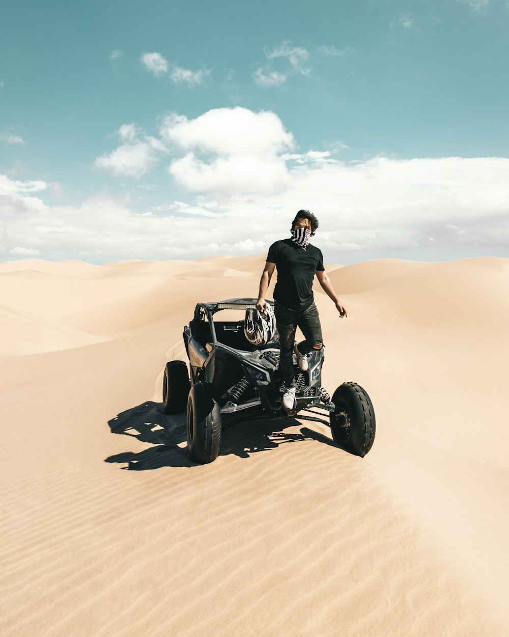 man in black jacket sitting on black sports bike on desert during daytime